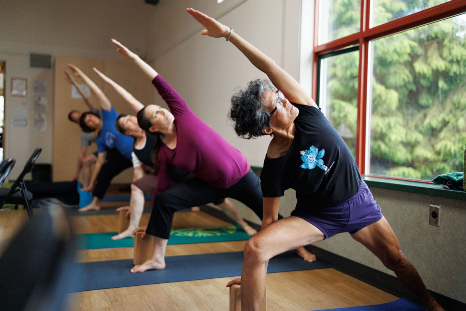 People practicing yoga in a studio.